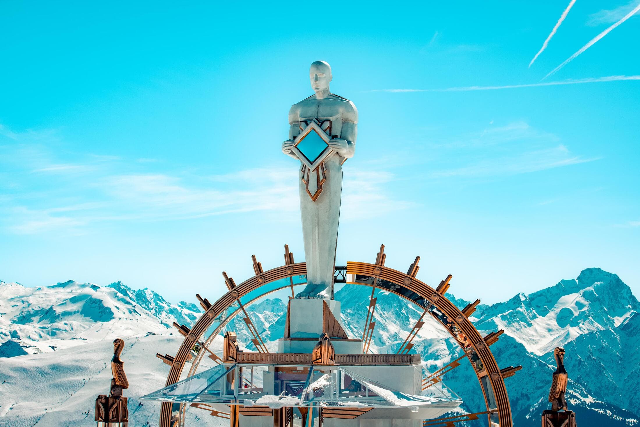 Tomorrowland Winter MainStage in Alpe d’Huez surrounded by snow-covered French Alps under a bright blue sky.
